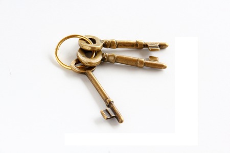 vintage golden keys are on white background.の写真素材
