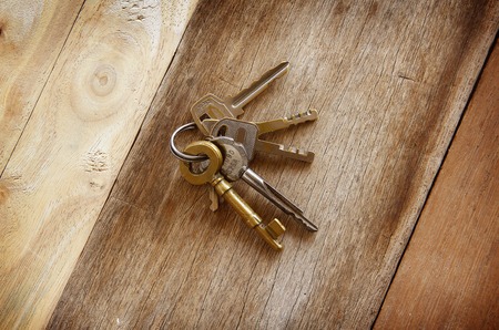 vintage golden keys are on woonden background.の写真素材