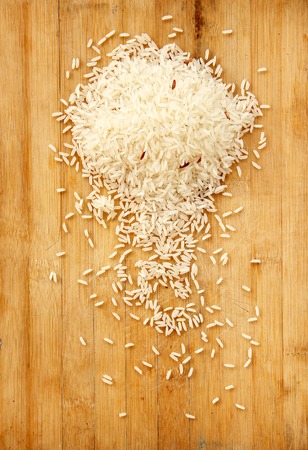 white rice is on wooden background.の写真素材