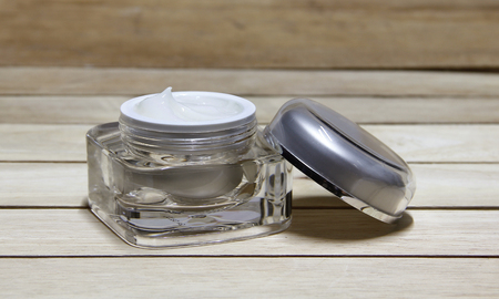 cometic cream is on wooden background.の写真素材