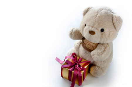 Cute Teddy Bear with Elegance Golden Gift Box for Celebration. Abstract of Elegance Jubilee Occasion Background and Banner Festival.の写真素材
