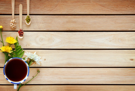 A cup of tea with flowers decorated with copy space wooden for Relax and calming down on top view. Background template concept.の写真素材