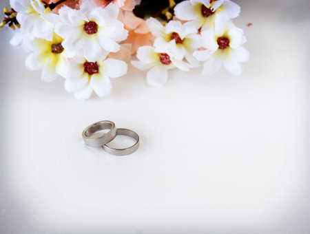 Pair Of Wedding Rings are elegantly displayed. Background Sweet Love Template with copy space for the Valentine's Day Concept banner.の写真素材