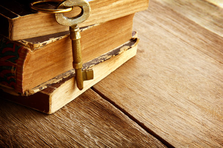 Vintage golden keys are on a wooden background for the mysterious, elegant vintage bannerの写真素材