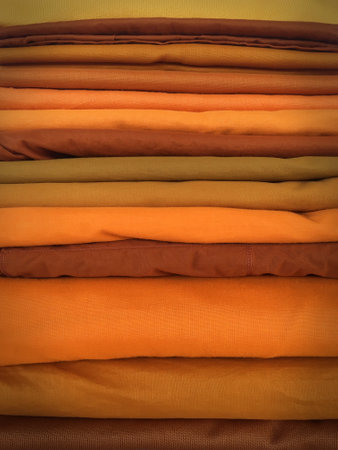 The Yellow robe in many Earth tones for the monk. The yellow fabric of a Buddhist Monk or A Buddhist Novice. Texture and Background Concept.の写真素材
