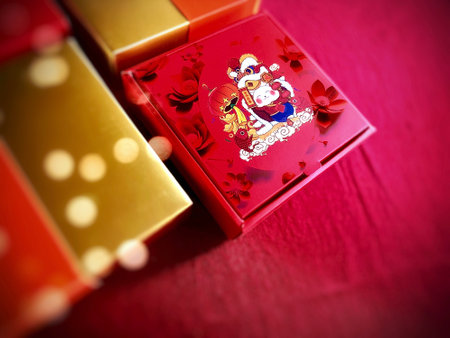 The auspicious Red gift box for Chinese New Year celebrations displayed with the red copy space for...