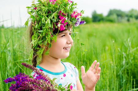 Smiling girl with big bouquet of spring flowers on green grass. Mothers day conceptの写真素材