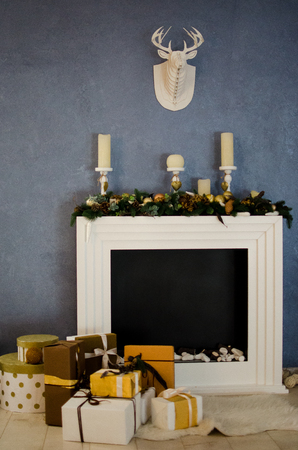 Christmas and New Year's fireplace with candles and giftsの写真素材