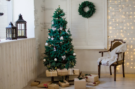 Background with Christmas tree, gifts, chair and Christmas wreathの写真素材