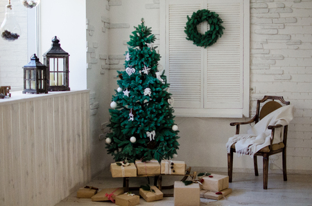 Christmas tree with gifts in the interiorの写真素材