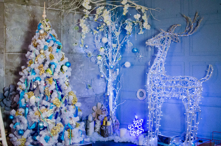 Glowing Christmas deer near a Christmas treeの写真素材