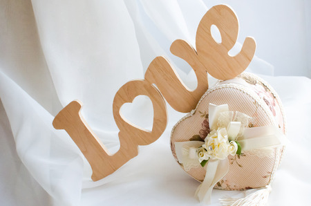 The word love is made of wood white backgroundの写真素材
