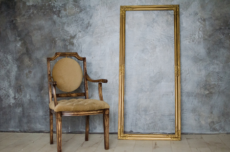 chair and frame on a background of gray wallの写真素材
