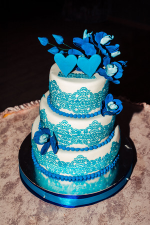 Three-tier wedding cake with a blue border at the wedding celebration, for the newlywedsの写真素材