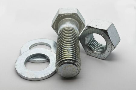 Steel nut, bolt and washers on white background