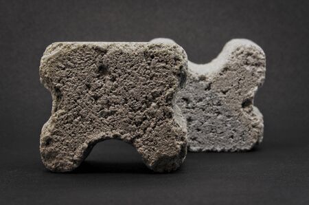 grey concrete spacers isolated on black backgroundの写真素材