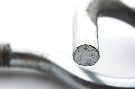 Steel pigtail screw hook on white background. Safety piece of hardware.の写真素材