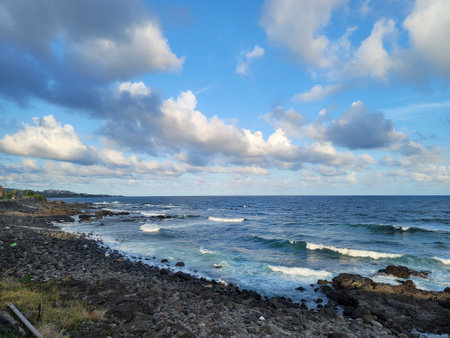 Landscape of rocky coast of the Mediterranean Sea with blue cloudy skyの写真素材