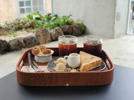 Breakfast with coffee and croissants on a wooden tray.