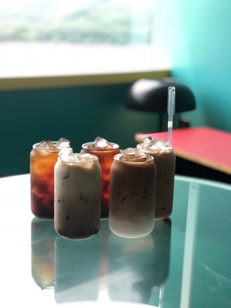 Iced coffee with milk on glass table in coffee shop, stock photo