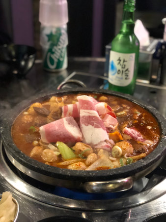 Korean style hot pot with pork and vegetables in the restaurant.の写真素材