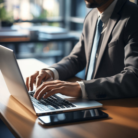 Cropped image of businessman using laptop while sitting at table in office.Generative AIの素材