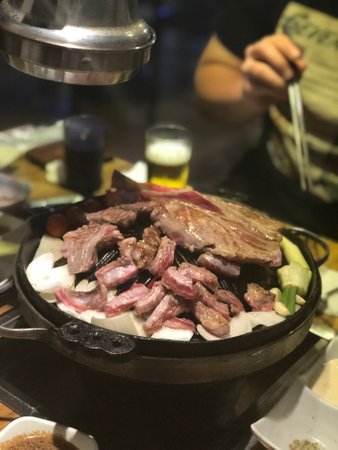 Beef sizzling on hot pot in a Japanese restaurant.の写真素材