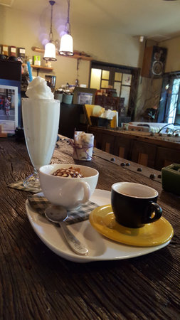Coffee and milk in a cafe on a wooden table.の写真素材