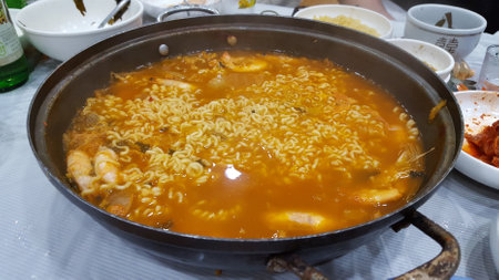 Fried noodle soup with shrimp in a frying pan on the tableの写真素材