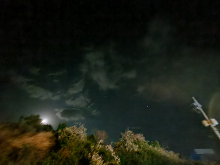 Night sky with full moon and stars, long exposure photograph with grainの写真素材