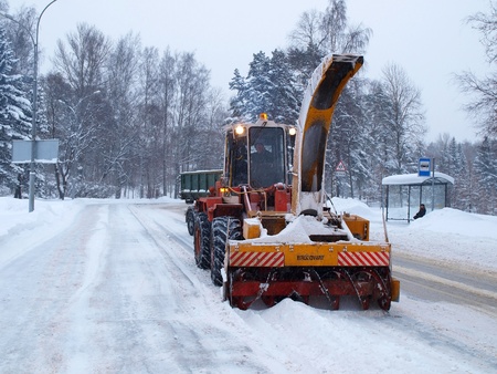 SAINT-PETERSBURG, RUSSIA- DECEMBER 12: Snow removal machine with an unidentified driver clean snow-covered road after cyclone called Monica on December 12, 2010 in Saint-Petersburg, Russia        のeditorial素材
