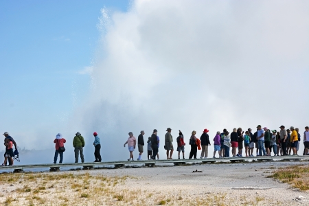 YELLOWSTONE NATIONAL PARK, MONTANA - AUGUST 11  People near the big geyser in Yellowstone national park on August 11, 2013  Yellowstone is famous national park in USAのeditorial素材