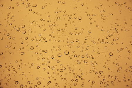 Water drops on the glass as a backgroundの写真素材