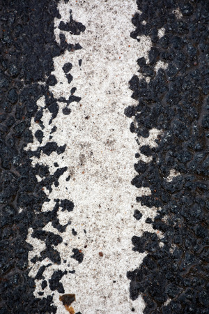 Strip of white paint on the asphalt roadの写真素材