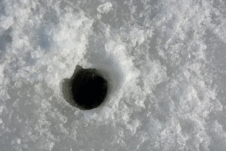 Winter fishing. Ice fishing- hole in the iceの写真素材