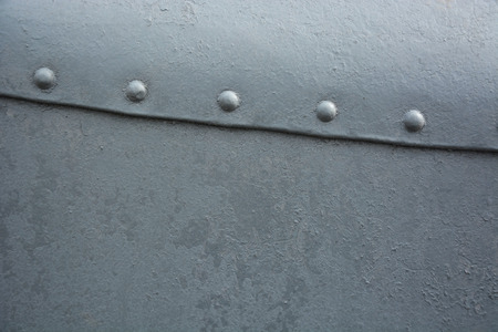 Grey metal background with rivets. Closeup viewの写真素材