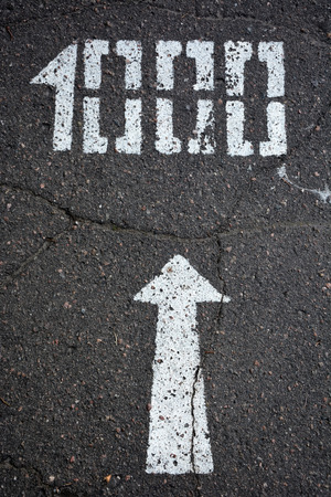 White arrow and distance 1000 meters on traffic surfaceの写真素材