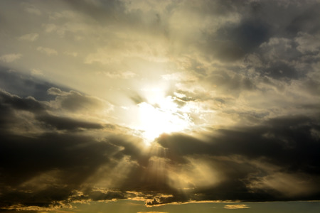 Sun through the stormy clouds. Natural backgroundの写真素材