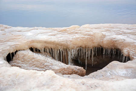 The frozen coast of the Gulf of Finland with a bizarre form of ice. Zelenogorsk, Russia, spring...