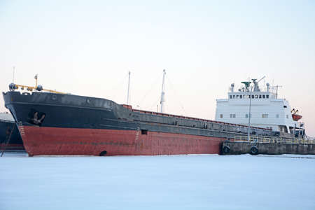 Old frozen cargo ships in the port on Onega lake in winterの写真素材