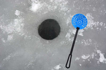 winter fishing. Ice fishing - hole in the iceの写真素材