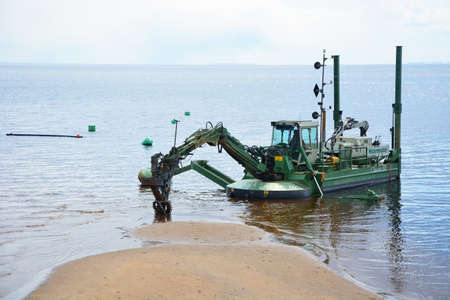 ZELENOGORSK, RUSSIA- APRIL 05: Excavator on the sea shore in Zelenogorsk on April 05, 2014....