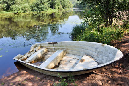 Old boat on the river shoreの写真素材