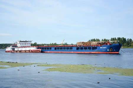 SAINT-PETERSBURG, RUSSIA- AUGUST, 21, 2018: Big ship with wooden cargo on Neva riverのeditorial素材
