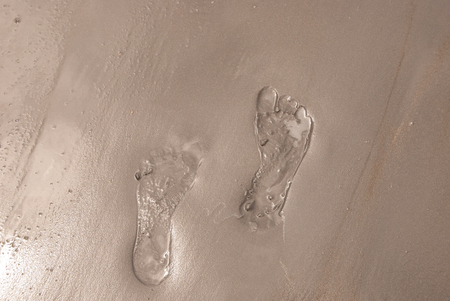 Two foot prints in the sandの写真素材