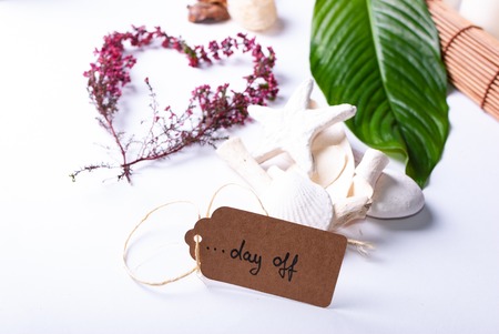 A set up of wellness items, a bamboo mat, a shell, candles, a branch, wood, a starfishの写真素材