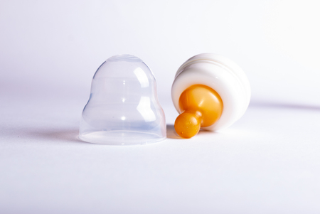 Close up of a pacifier comforter of a disassembled baby bottle with natural rubber on white backgroundの写真素材