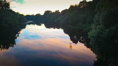 A river reflecting the skyline and the colorful skyの写真素材