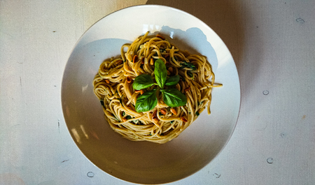 Close up of self made vegan spaghetti's with nuts, spinachの写真素材