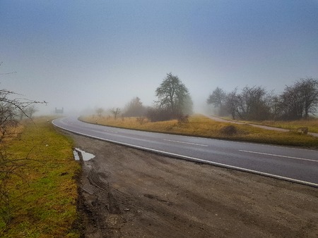 A lonely street leading into the foggy horizonの写真素材